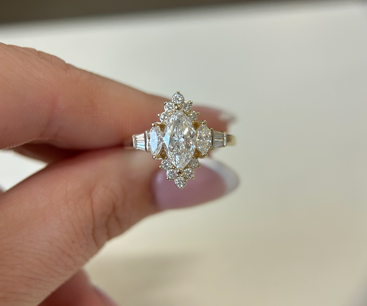 Marquise center-stone engagement ring with diamond accents in yellow gold